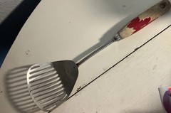 vintage slotted metal spatula turner with red chippy wood handle