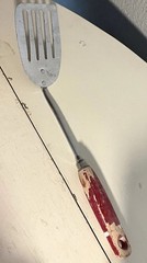vintage slotted metal spatula turner with red chippy wood handle